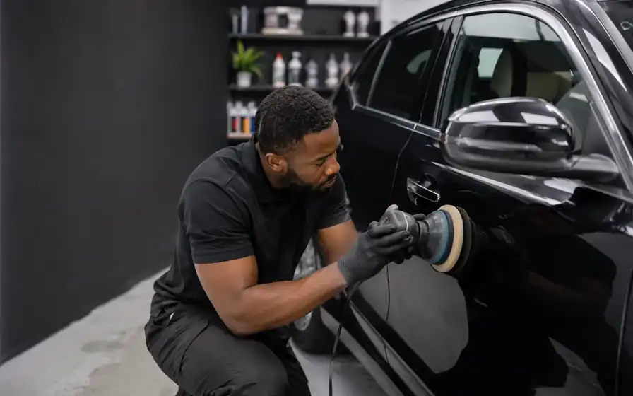 Professional car detailer working on a vehicle